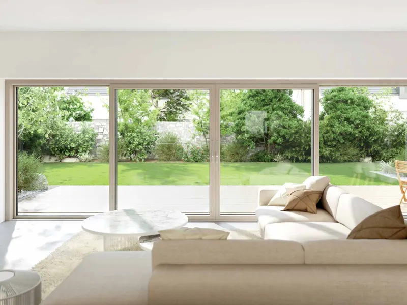Living room with wide multi-panel white uPVC sliding doors opening to a garden