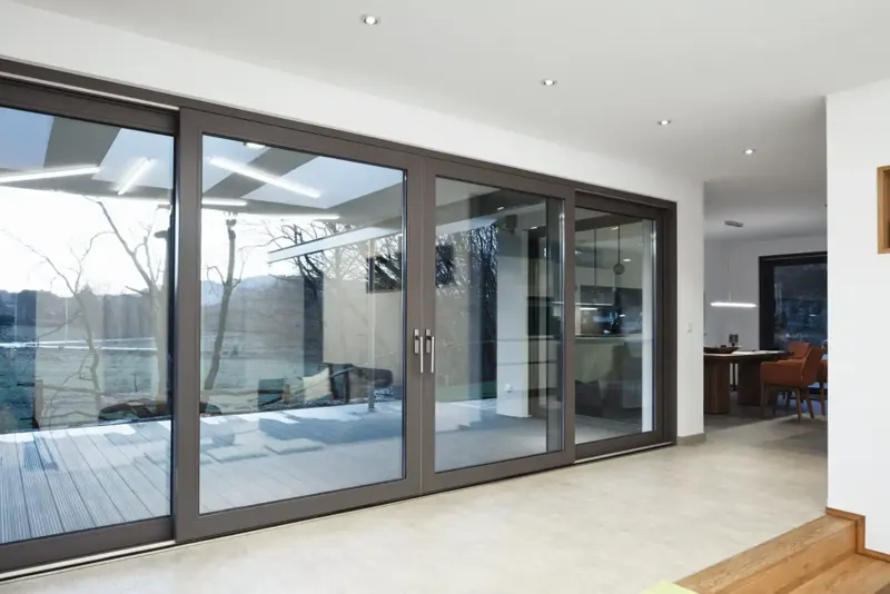 Large Schueco lift and slide door opening onto a deck
