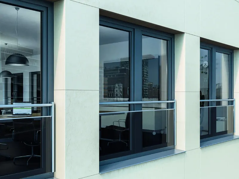 Rendered facade with dark full-height uPVC windows behind stainless bar fall protection